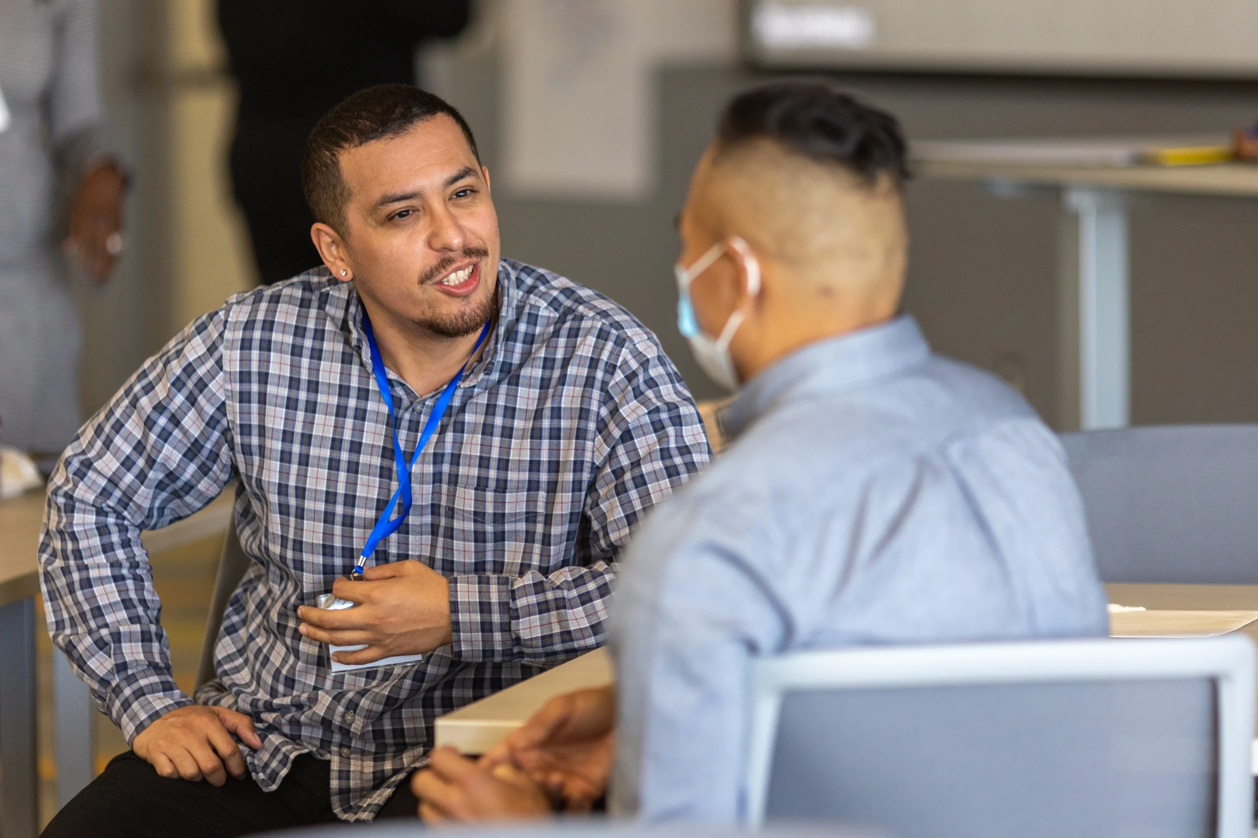 Two men having a conversation at a table